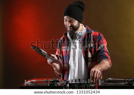 Male DJ playing music in club