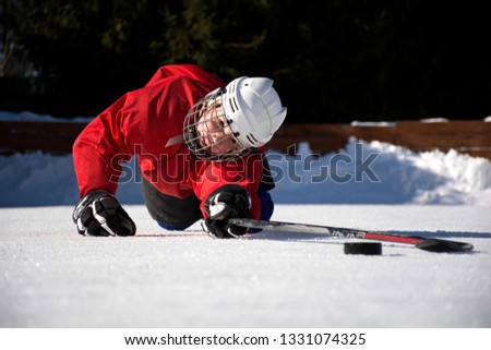 Boy playing hockey on the street.Boy hockey player on the ice.Ice hockey.