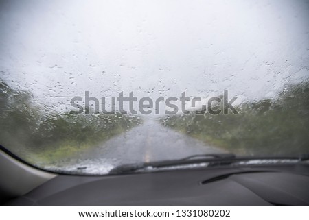Rain on the road seen from inside the car