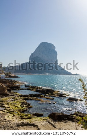 Ancient roman ruins, Banos de la Reina, the Baths of the Queen in Calpe beach, Spain. The Penon of Ifach mountain is in the background