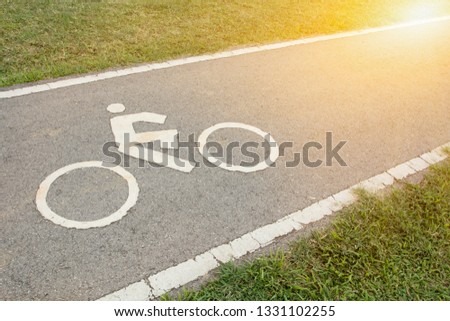 Bicycle lane for riding bicycles. White painted bike on asphalt , Ride ecological green urban transport concepts