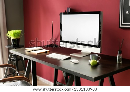 Stylish workplace with computer in modern room