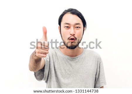 Portrait of happy smiling asian young handsome man with thumb up on white background