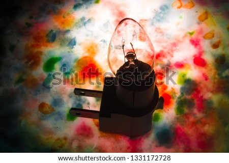 conceptual art of a light bulb with colorful backgrounds