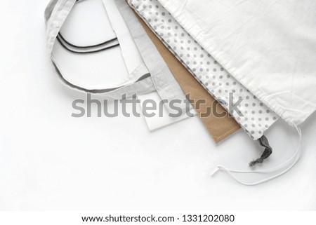 Cotton and paper bags for free plastic shopping. Shopping bags on white background.