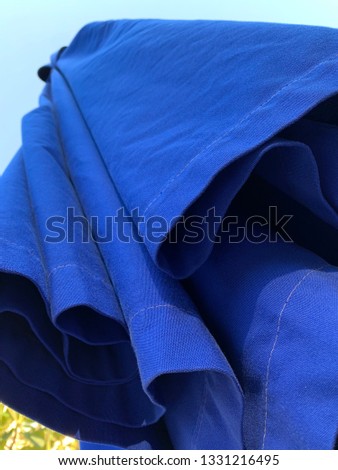 blue pool umbrella at hotel traveling