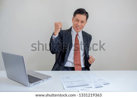 Businessman smiles when he working in the office.