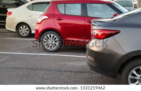 Closeup of back or rear carlight of brown car and other cars parking in outdoor parking area in twilight evening. The mean of transportation in modern world. Royalty-Free Stock Photo #1331219462