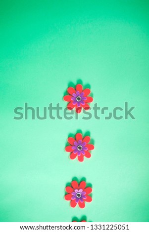 beautiful minimal bright colorful close up top view flat lay photo of small fake flowers on bright background with copy space