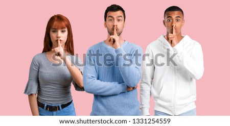 Group of three friends showing a sign of closing mouth and silence gesture