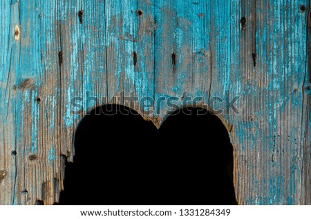 Old broken heart in a blue wooden door