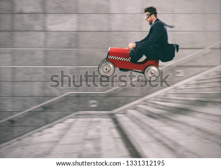 Reckless business man goes down the stairs with a car to get before the others. Concept of success and competition Royalty-Free Stock Photo #1331312195