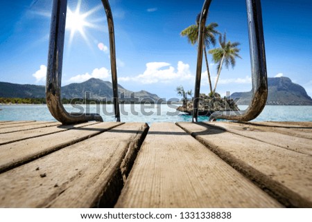 Summer wooden pier and sea landscape with sunny sky of blue color. 