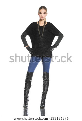 Full body portrait of a beautiful young female in gloves standing posing