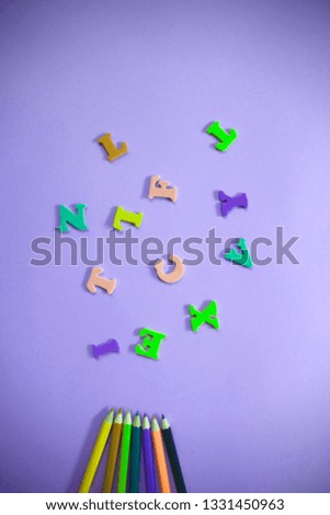beautiful bright fun kids flat lay top view close up colorful photo of wooden crayons and letters on clean background with copy space