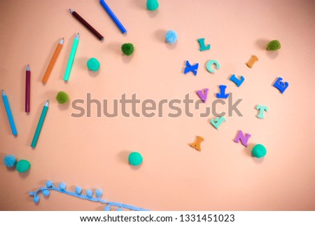 beautiful bright fun kids flat lay top view close up colorful photo of wooden crayons and letters on clean background with copy space