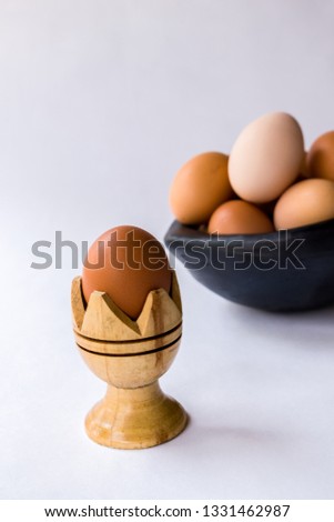 eggs in clay bowl on white background