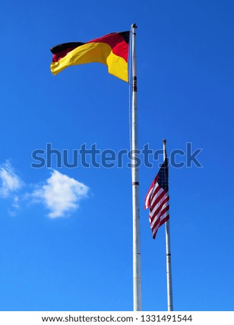American and German flags waving in the wind. 