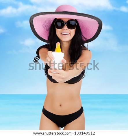 woman smile hold moisturizing applying sun cream, summer vacation beach, sun tanned body, girl wear pink hat, sunglasses, over sea blue sky, concept holiday travel
