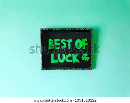 Phrase "Best of luck" and shamrock on green background for St. Patrick's Day