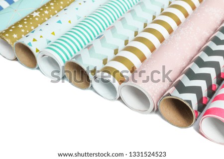 Rolls of festive wrapping paper on white background. Space for text