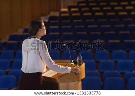 Side view of blonde Caucasian businesswoman practicing for speech in the empty auditorium Royalty-Free Stock Photo #1331533778