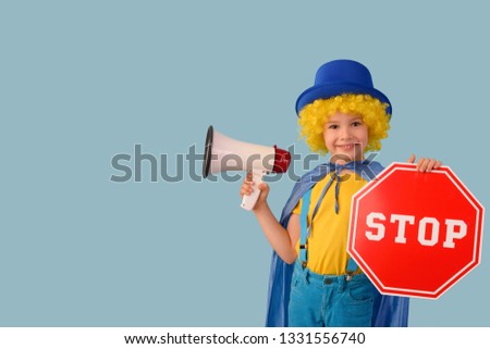 Little boy with a megaphone and a stop sign.