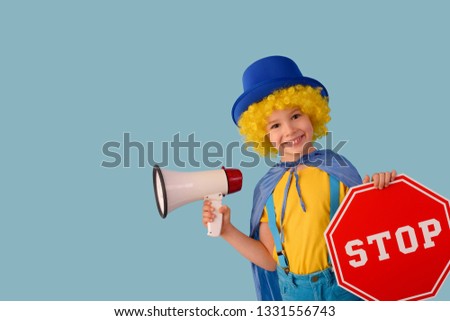 Little boy with a megaphone and a stop sign.