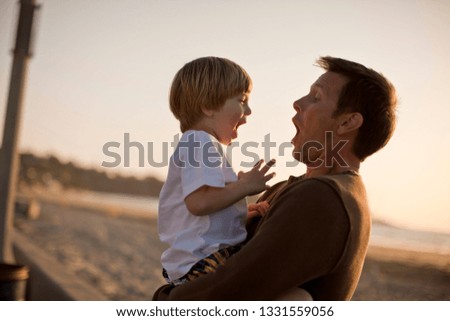 Father playing with son at the beach