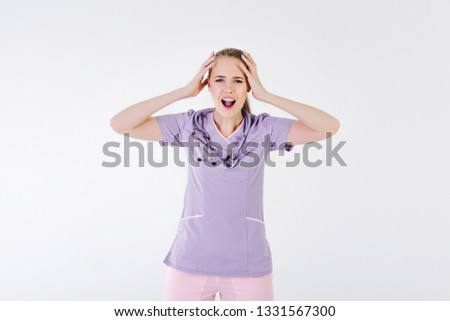 Woman doctor blonde young light gray background studio day beautiful one stethoscope pink purple lilac clothes tired of hard work. dissatisfied  boss not sleep.