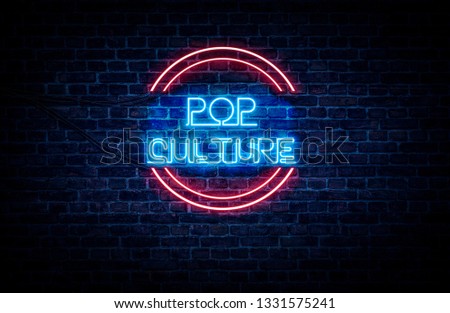 A neon sign in blue and red light on a brick wall background that reads: POP CULTURE