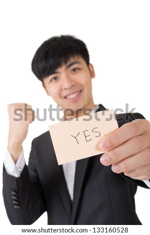 Asian businessman holding a card written on "yes", closeup portrait.