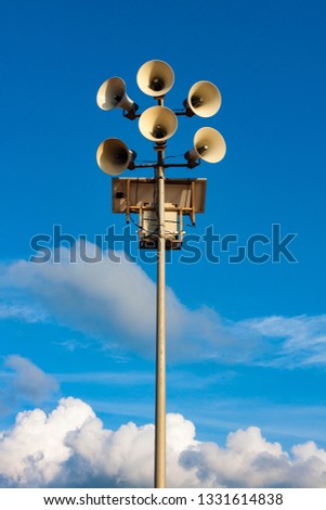 MEGAPHONES ON THE BEACH ON THE BACKGROUND OF HEAVEN AND CLOUDS Royalty-Free Stock Photo #1331614838