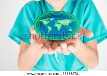 Love earth save our planet paper cut on boy's hand 