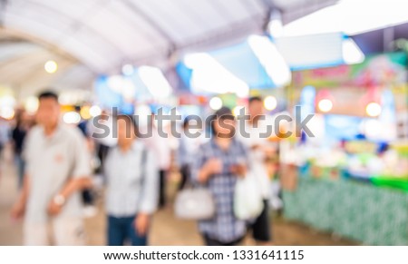 Abstract Blurred image of People walking at Day market on street  with bokeh for background usage .