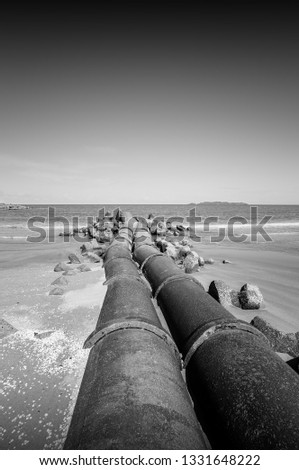 Old abandon pipeline in beautiful minimalist black and white fine art photography. Long exposure technique. (blurry soft focus noise grain visible full resolution) Nature composition