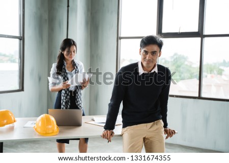 young asian businessman crossed arm looking at camera