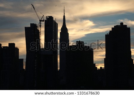 New York City silhouette skyline at sunset with stuning orange and blue sky