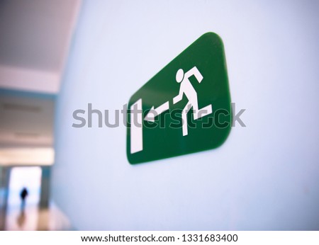 Fire exit sign at the corridor in building
