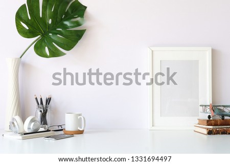 Mockup workspace desk and copy space books,plant and coffee on white desk.  Royalty-Free Stock Photo #1331694497