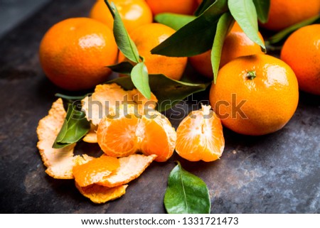 Sweet juicy mandarines on the rustic background. Selective focus. Shallow depth of field.