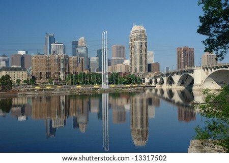     A picture of downtown Minneapolis with reflections in river
