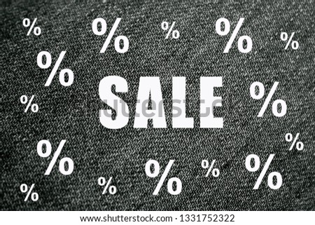 Word sale on black jeans background