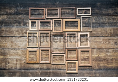 vintage poto frames on old wooden wall