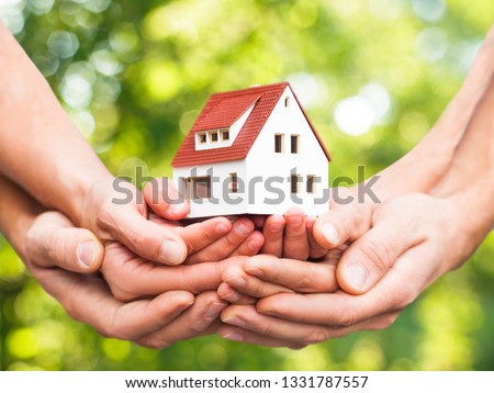 closeup picture of hands holding the house
