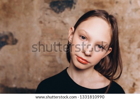 Cheerful beautiful close up portrait of young adorable teenage model posing in studio. Fashion kids,beauty, teenage girl concept