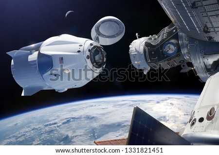 Cargo spacecraft in low-Earth orbit. Elements of this image furnished by NASA. Royalty-Free Stock Photo #1331821451