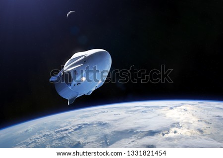 Cargo spacecraft in low-Earth orbit. Elements of this image furnished by NASA. Royalty-Free Stock Photo #1331821454