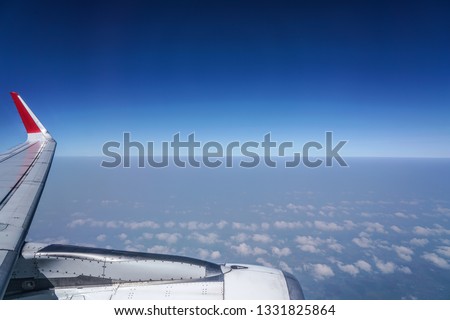 View of clear sky and airplane from aircraft cabin.