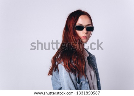 Smart cute young hipster girl in fashionable sun glasses on white background, Fashion, education, sun glasses concept